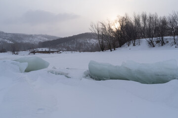 Winter sunset on the big river, hummocks in the rays of the sun.