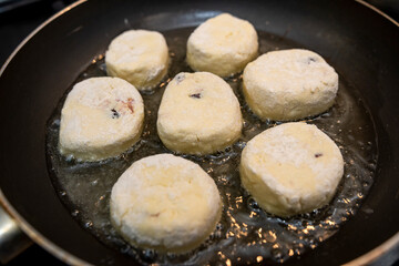 Homemade tasty cheesecakes are fried in pan,  traditional dish Ukrainian
