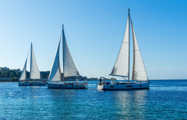 Fototapeta na wymiar boats and yachts at the sailing regatta on open water. Sailing on the wind waves in the sea.