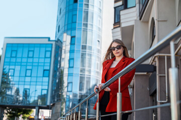 Businesswoman boss talking on the phone and looking at the clock on  beautiful office.