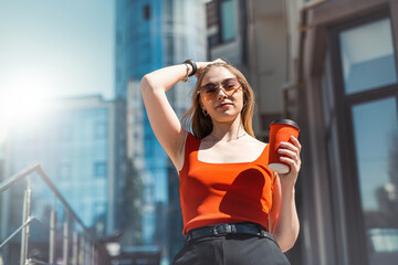 woman in her hands with makeup and glasses looking to the side while standing near her office