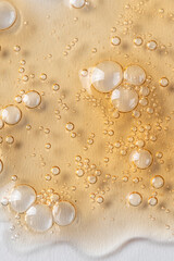 Close uo of yellow liquid with bubbles .Oil, gel serum texture. Cosmetic skin care