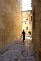 Fototapeta na wymiar tourist walking in the streets of the old stone town of Rabat
