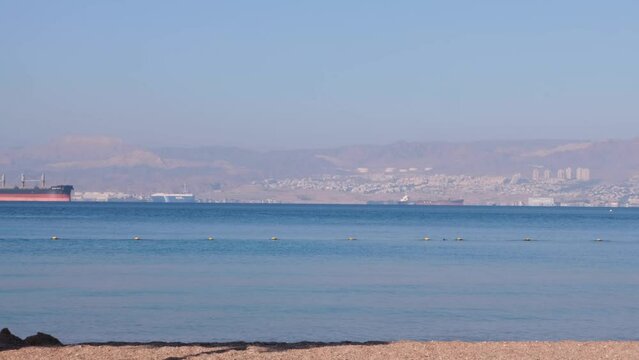 Panoramic view of Eilat City in Israel, busy port and vacation resort on the Red Sea, as seen from Aqaba in Jordan, Middle East