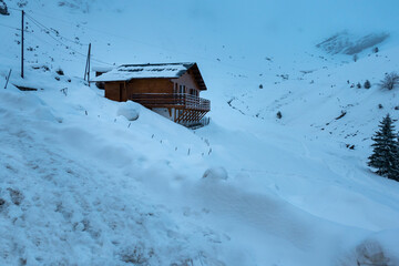 Casa de madeira a meio de um manto de neve na montanha num dia frio de inverno nos Pirenéus...