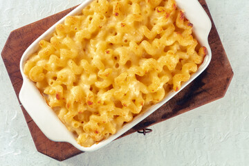 Macaroni and cheese pasta in a casserole, shot from the top. Cheesy American comfort food,...