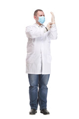 Young doctor puts on gloves and wearing medical mask