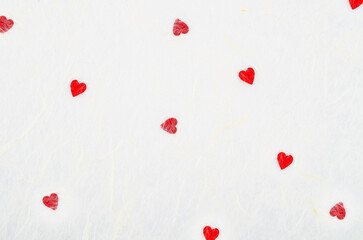 The Abstract blurred of red heart on white mulberry paper texture, suitable for a background. Valentine day.