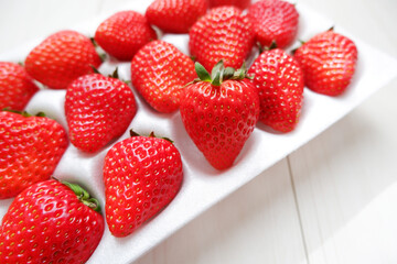 Red ripe strawberry in plastic package. Fresh strawberries. Seasonal fruits. 