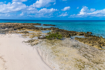 A view out to sea from a deserted bay on the island of Eleuthera, Bahamas on a bright sunny day