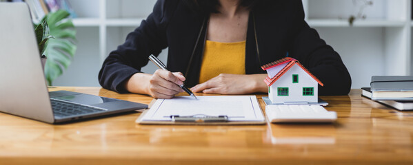 Businesswoman, real estate agent reading documents and legally signing contract agreement.