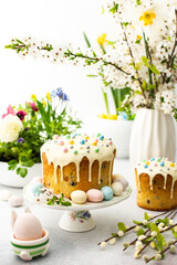 Easter home interior, Easter cake with eggs on the background of a vase with blossoming cherry...