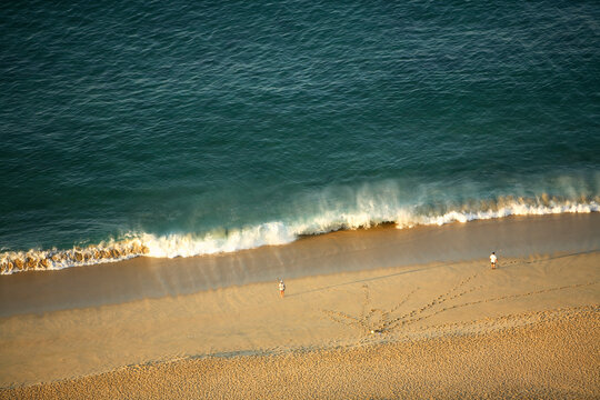 A couple of surfcasting fishermen try their luck along the Pacific beach at Cabo San Lucas in Baja, Mexico.