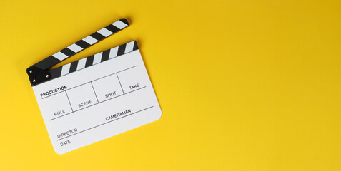 Clapper board or white movie slate on yellow background.