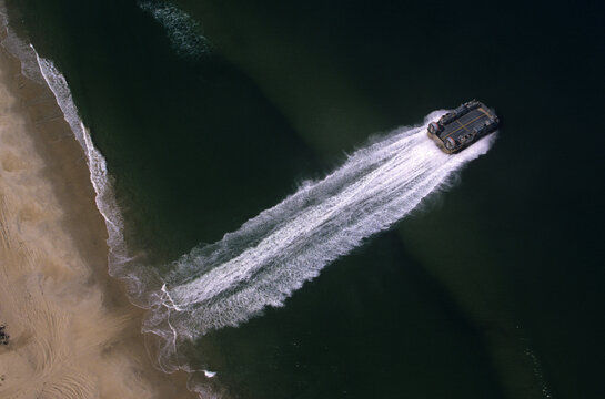 Amphibious transport craft moving from beach to water at Virginia Beach, VA.