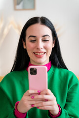 Smiling woman taking selfie at home