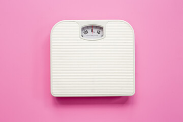 White weight scales on the floor. Weight measurement and loss concept - obrazy, fototapety, plakaty