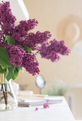 Bouquet of Violet lilac in a vase on the dressing table. Close up
