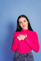 Smiling woman with hands on chest