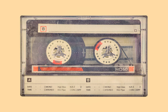 Retro styled image of a vintage audio compact cassette in a plastic storage box