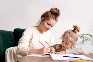 Happy mom engaged in her child's development, homeschooling in a friendly environment