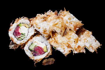 sushi roll with tuna avocado cucumber cream cheese on a black mirror background