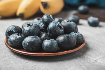 Fresh blueberries in a plate on a table, close up view