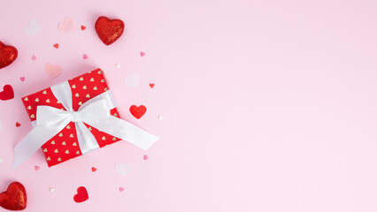 Concept gifts for your loved ones, for valentines day, womens day, mothers day or birthday. Red wrapped gift box, various hearts around