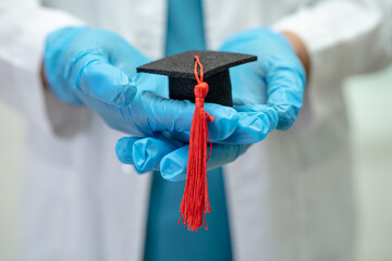 Asian doctor study learn with graduation gap hat in hospital ward, clever bright genius education...