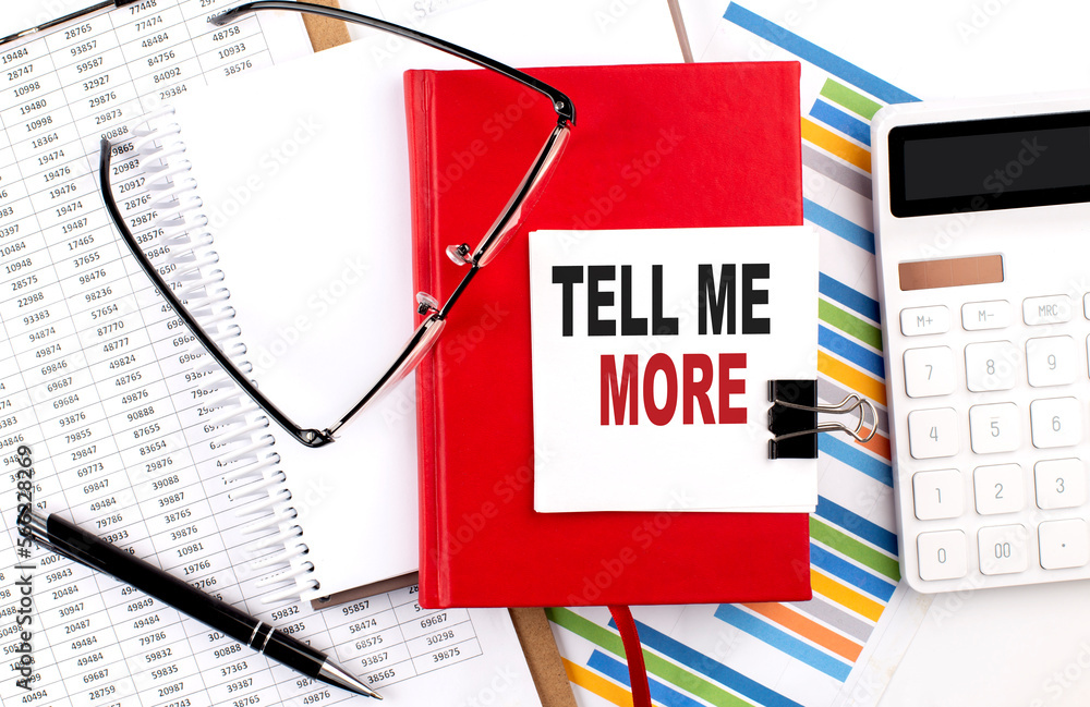 Poster tell me more text on sticky on red notebook on the chart background