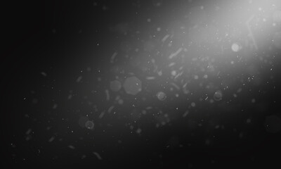 Fototapeta premium A beam of white light with flying dust on a black background. Winter background with flying snow. Snowstorm, blizzard, dust. High quality photo