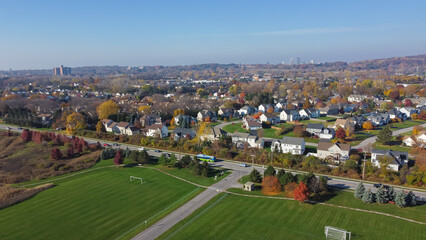 Large soccer fields near upscale residential neighborhood in Monroe County with downtown Rochester, Upstate New York in background - obrazy, fototapety, plakaty