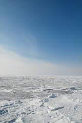 View of a frozen lake and a blue winter sky (Kapchagay - Qonaev, Almaty region, Kazakhstan).