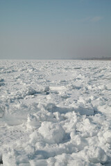 View of a frozen lake and a blue winter sky (Kapchagay - Qonaev, Almaty region, Kazakhstan).