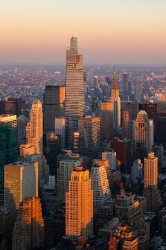 New York City aerial view of midtown Manhattan skyscrapers at sunset. The elevated view includes a new supertall building