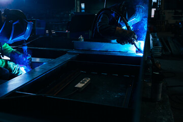 Workers welding metal.