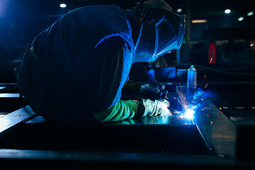 Man welds at factory.