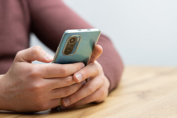 Man hands holding smartphone. Man using smartphone and pointing on the screen with one finger
