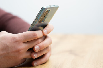 Man hands holding smartphone. Man using smartphone and pointing on the screen with one finger
