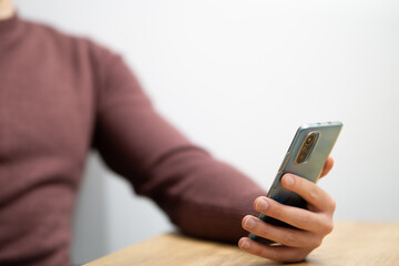 Man hands holding smartphone. Man using smartphone and pointing on the screen with one finger