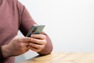 Man hands holding smartphone. Man using smartphone and pointing on the screen with one finger