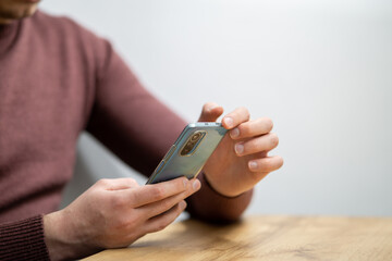 Man hands holding smartphone. Man using smartphone and pointing on the screen with one finger