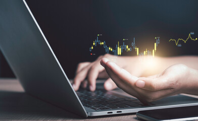 Businessman used laptop read candlestick graph investment diagram report idea chart virtual hologram. Planning and strategy, Stock market, Business growth, progress or success, invest in trading.