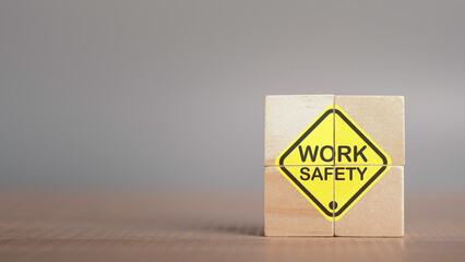 Work safety concept. Work Safety text yellow in wooden cube and copy spec. Safety first sign on virtual screen. Hazards, protections, regulations and insurance, Zero accidents, Protection dangerous.