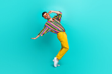 Full size photo of funny cheerful playful guy brunet haircut wear colorful shirt fingers hold glasses isolated on teal color background
