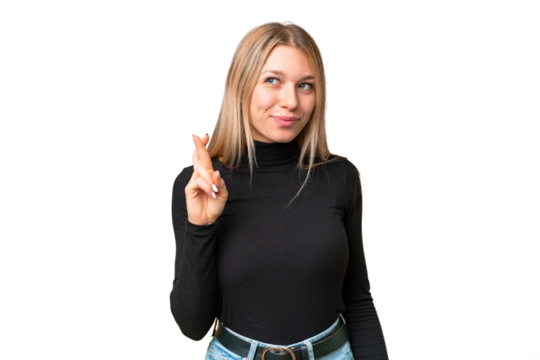 Young pretty blonde woman over isolated chroma key background with fingers crossing and wishing the best
