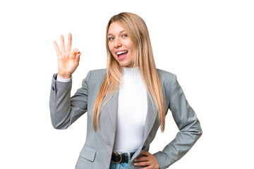 Young pretty blonde woman over isolated chroma key background showing ok sign with fingers