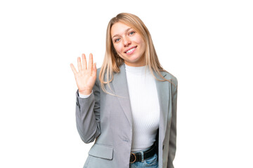 Obraz premium Young pretty blonde woman over isolated chroma key background saluting with hand with happy expression