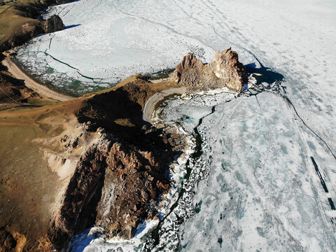 Aerial view of the village of Khuzhir, Cape Burhan or Shamanka Rock, Olkhon Island. Lake Baikal in the spring during the melting of the ice