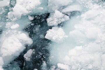 Snow and ice in the water. Natural background. Top view.